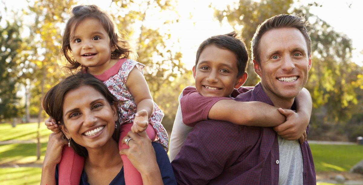 Woman and man with children on their shoulders