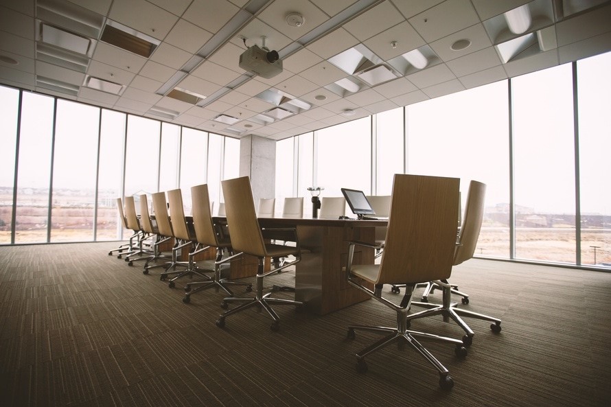 chairs around boardroom table in windowed boardroom