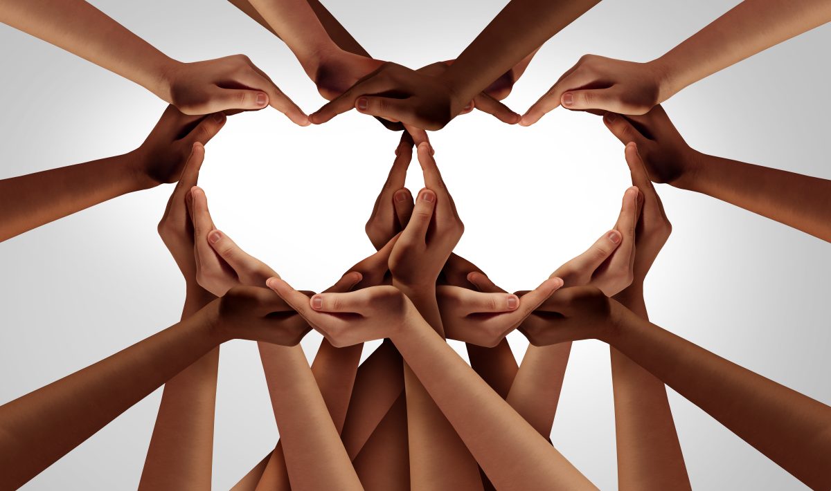 many multicultural hands forming two hearts