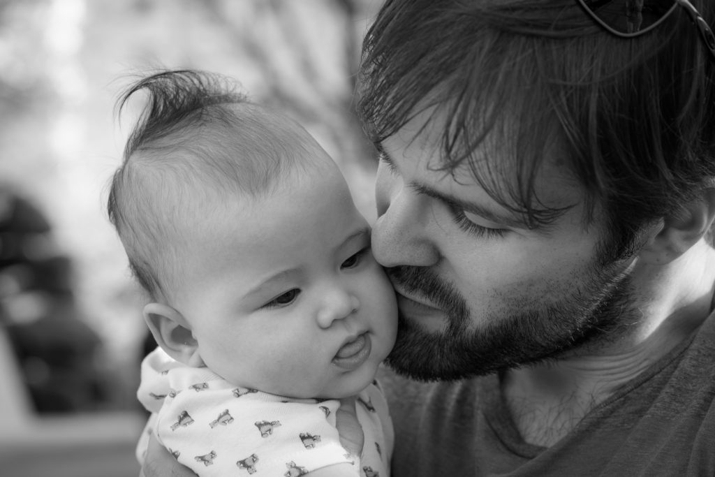 young man holding baby